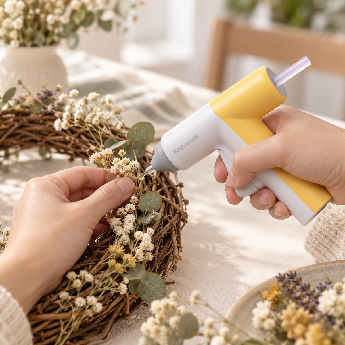 Adult crafting a floral wreath with the CREATOR G1 hot glue gun